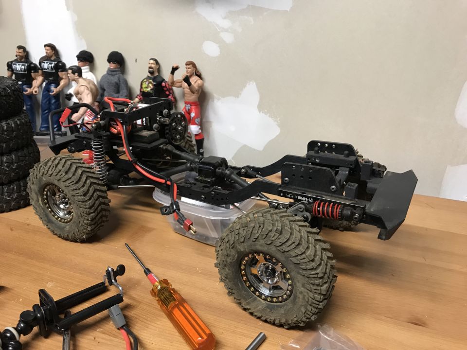 RC crawler chassis with large tires and suspension components