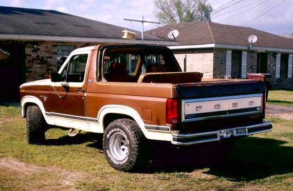 1980 Ford Bronco, brown and white, rear view. Ford lettering on tailgate