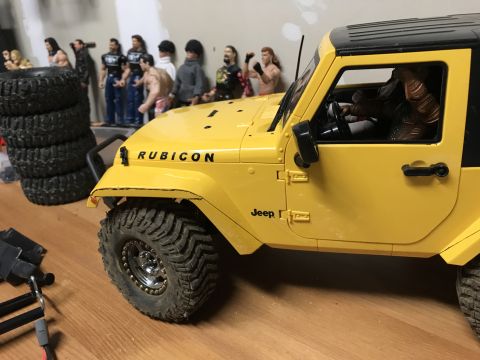 1989 Ford Bronco - A yellow Jeep Wrangler model is shown with "Rubicon" and "Jeep" text visible on its body.
