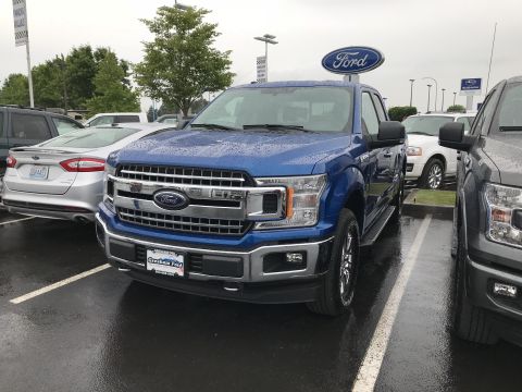 2018 Ford F-150 - Front view of a blue 2018 Ford F-150 pickup truck at a dealership.