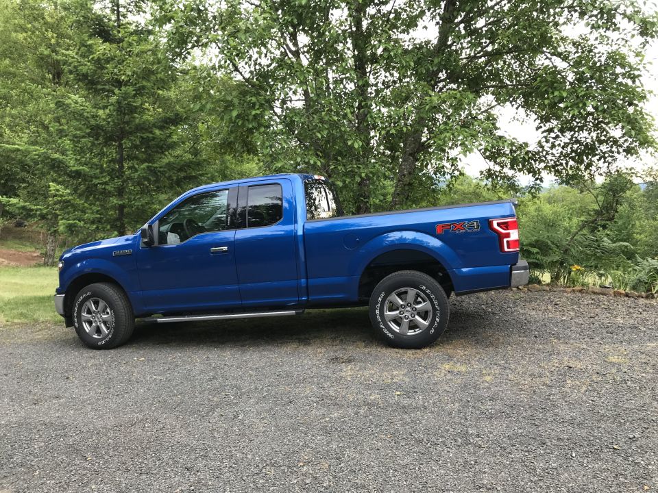 Blue 2018 Ford F-150 pickup truck, side view