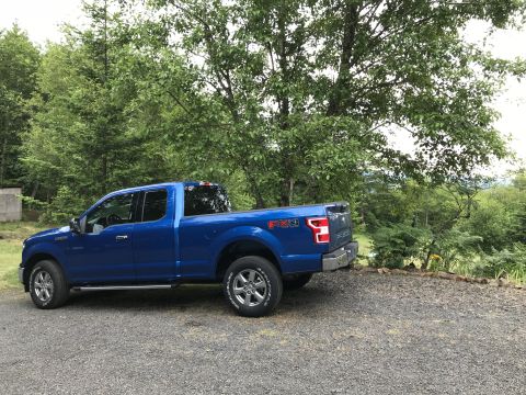 2018 Ford F-150 - Blue 2018 Ford F-150 SuperCrew parked outdoors on a gravel surface.