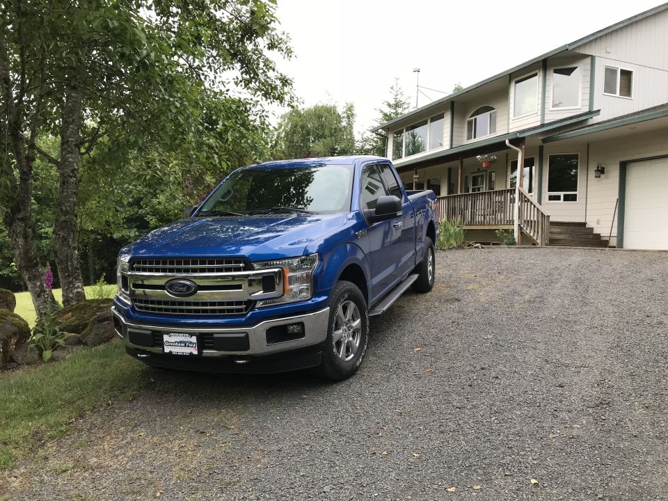 Blue 2018 Ford F-150 parked in driveway