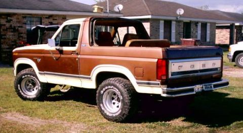 1980 Ford Bronco - Rear view of a two-tone brown and white 1980 Ford Bronco with the top removed.