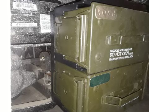 1994 Ford Bronco - Two green storage boxes are attached to what appears to be John Deere equipment, with text indicating they are packaged with desiccant.