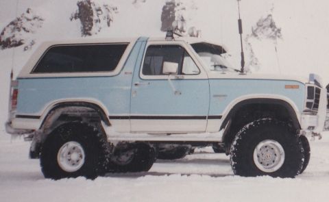 1996 Ford Bronco - This Ford Bronco, likely from the early 1980s, is equipped with oversized tires and appears to be in a snowy environment.