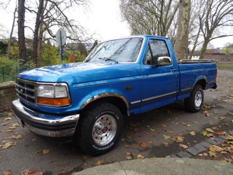1994 Ford F-150 - This blue 1994 Ford F-150 pickup truck is shown from a 3q-front angle.