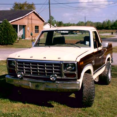 1980 Ford Bronco - This two-tone brown and white 1980 Ford Bronco is shown from the front 3/4 view.
