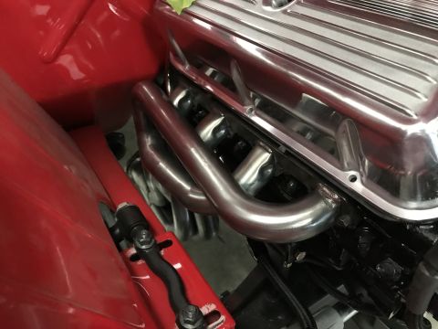 1964 Ford Fairlane - Engine bay detail showing chrome valve covers and headers, likely from a classic car.