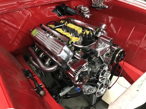 1964 Ford Fairlane - A highly polished V8 engine is installed in a vehicle's engine bay.