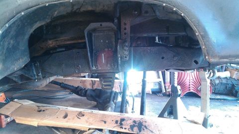 1978 Ford Bronco - Close-up view of a vehicle's undercarriage, showing suspension components and frame structure.