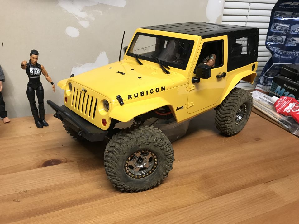 Yellow toy Jeep Rubicon with black top and off-road tires