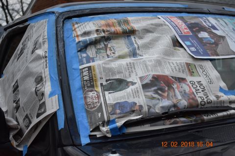 1996 Ford Bronco - Windshield masked with newspaper and blue tape, preparing for auto body work.