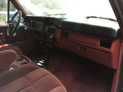 1986 Ford Bronco - Interior view of a 1986 Ford Bronco, showing the red seats and dashboard.