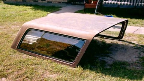 1980 Ford Bronco - A brown removable hardtop sits on the grass, detached from a vehicle.