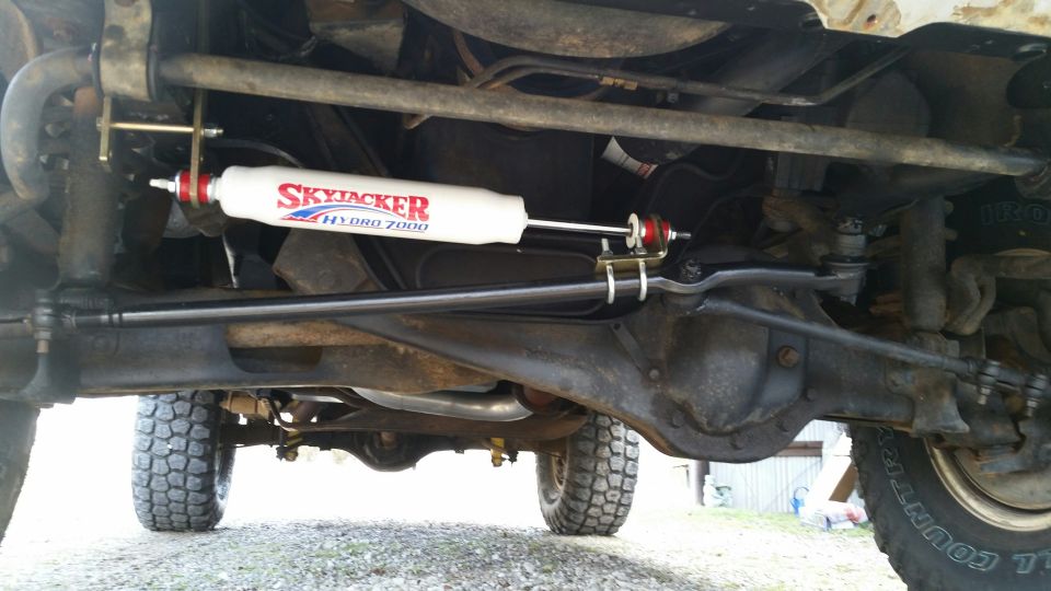 Undercarriage of a vehicle showing a Skyjacker Hydro 7000 shock absorber and steering linkage
