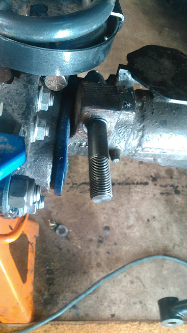 1978 Ford Bronco - Close-up of a vehicle's front axle assembly, showing mechanical components and a threaded stud.