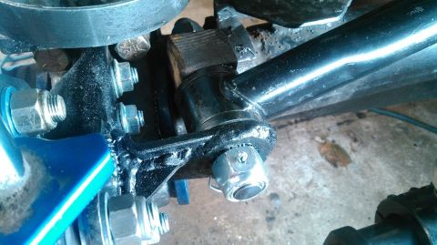 1978 Ford Bronco - Close-up view of front axle suspension components, showing various bolts and metal brackets during a rebuild.