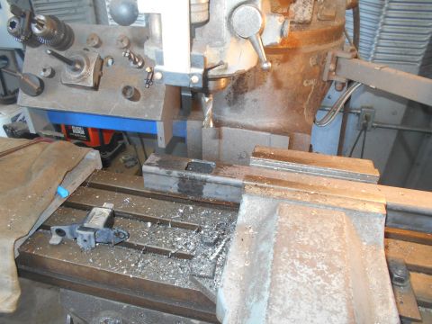 1992 Ford Bronco - A milling machine is set up for a machining operation with various tools and parts visible.