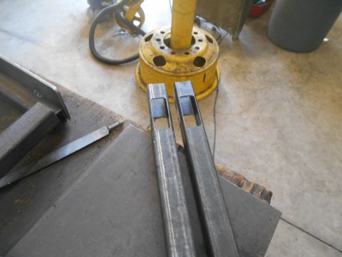 1992 Ford Bronco - Metal tubing and tools are laid out on a workbench, possibly for fabrication or repair.