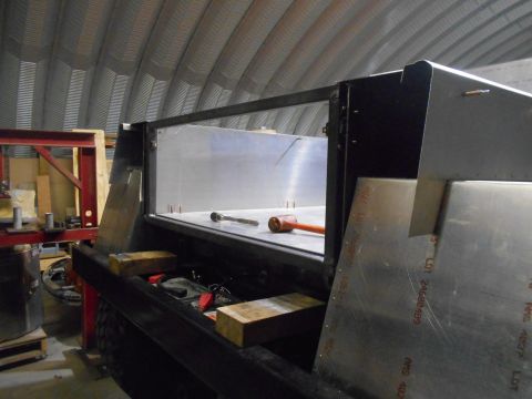 1992 Ford Bronco - A custom truck bed modification is underway, with metal panels and tools present.