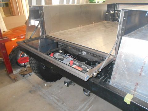 1992 Ford Bronco - Custom truck bed build in progress, a battery and electrical components.