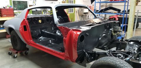 1970 Chevrolet Camaro - A partially restored 1970 Chevrolet Camaro is shown in a garage setting. The car's interior, firewall, and exterior body panels are visible…