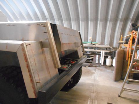 1992 Ford Bronco - The rear section of a custom-built metal truck bed is shown in a workshop setting. The bed appears to be under construction with visible me…