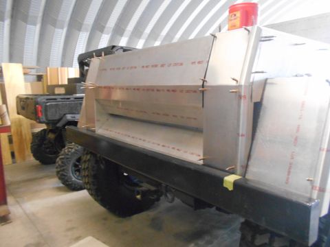 1992 Ford Bronco - A custom truck bed modification is shown, with text visible on the aluminum panels. Another vehicle is parked behind it in the garage.