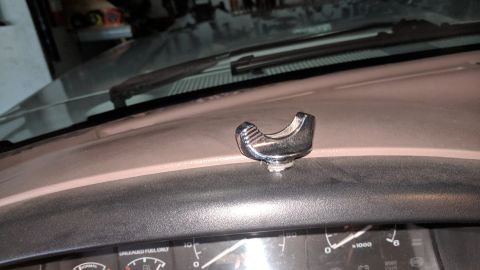 1995 Ford Bronco - A chrome knob is mounted on the dashboard of a vehicle, with gauges visible underneath.