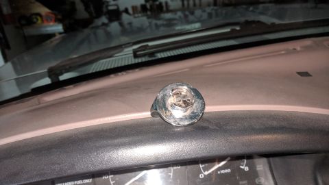 1995 Ford Bronco - Interior view of a vehicle's dashboard, showing a chrome knob and speedometer.