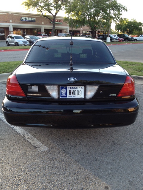 2008 Ford Crown Victoria - Rear view of a black 2008 Ford Crown Victoria police car parked in a lot.