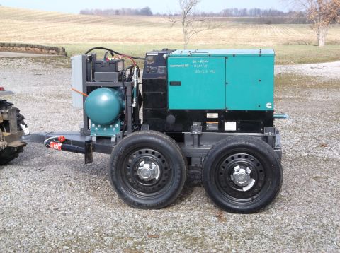 1984 Honda ATC 250 R - A portable generator unit is mounted on a trailer with dual wheels and a hitch.