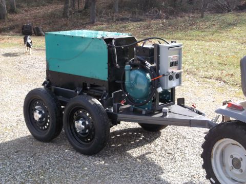 1984 Honda ATC 250 R - A trailer-mounted generator unit is shown with its teal housing and exposed engine parts.