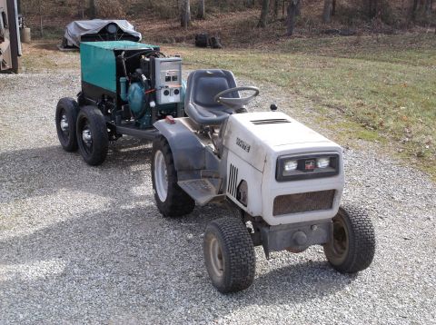 1984 Honda ATC 250 R - A White tractor tows a generator unit on a dual-axle trailer.