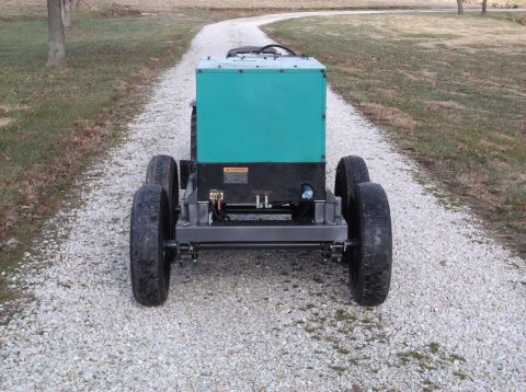 1984 Honda ATC 250 R - This generator unit is mounted on a wheeled chassis, seen from the rear on a gravel driveway.