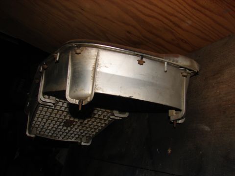 1973 Ford Ranchero - This appears to be a car part, possibly a bumper or headlight assembly, with chrome trim.