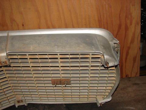 1973 Ford Ranchero - This grille assembly, likely from a 1973 Ford Ranchero, displays significant wear and rust on its metal components.