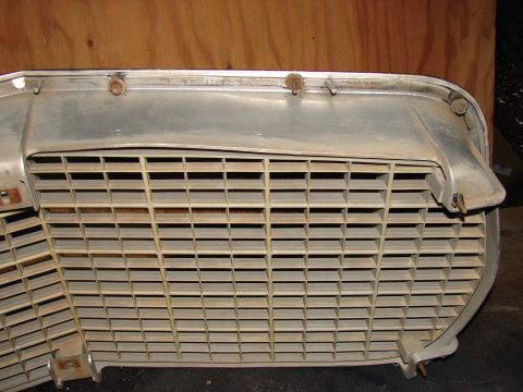 1973 Ford Ranchero - Close-up of a car grille, showing its horizontal slat design and chrome trim details.