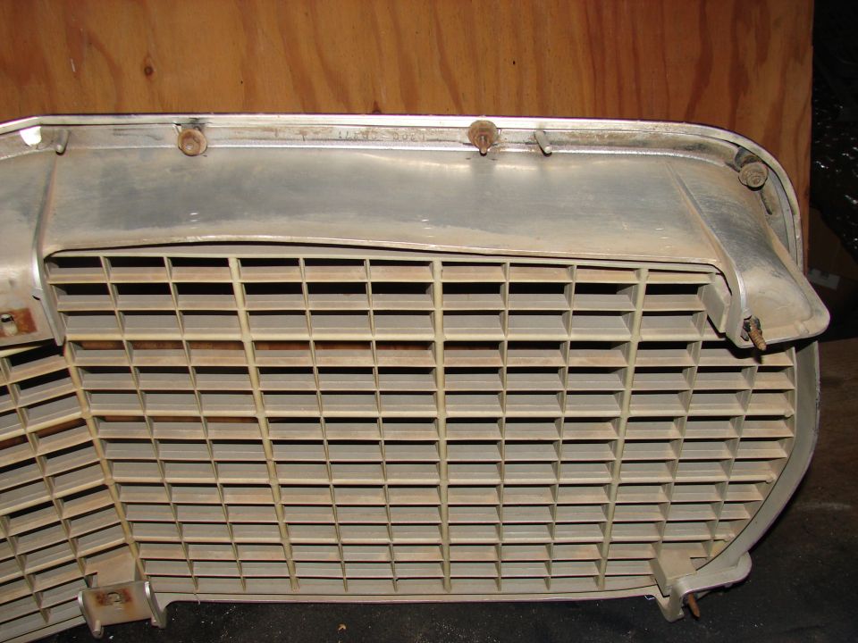 Close-up of a car grille with horizontal slats and chrome trim