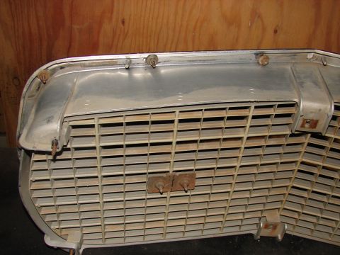 1973 Ford Ranchero - A close-up view of a vehicle's front grille, revealing its horizontal slat design and attachment points.