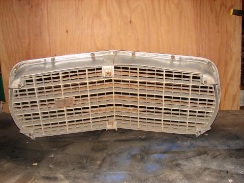 1973 Ford Ranchero - A detached car grille, likely from an older model, is shown against a wooden partition.
