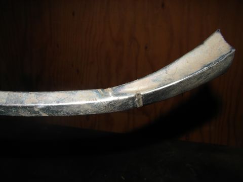 1973 Ford Ranchero - Close-up of a chrome trim piece, possibly from a vehicle part.