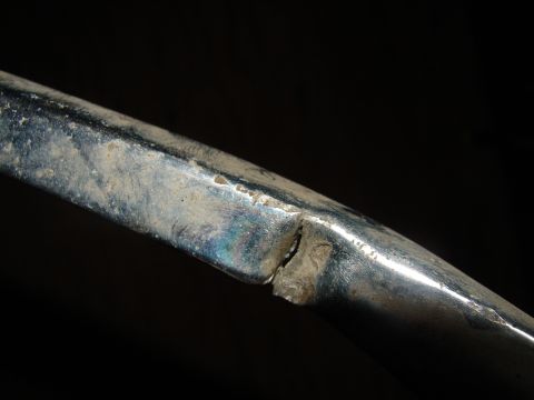 1973 Ford Ranchero - A close-up shows a damaged chrome trim piece with visible dirt and a significant crack.