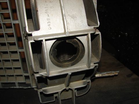 1973 Ford Ranchero - Close-up of an aluminum car part with a grid texture and a central circular opening, showing part numbers.