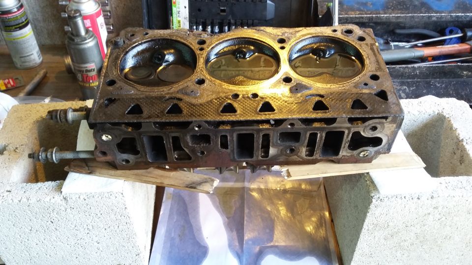 Engine cylinder head with three visible cylinders