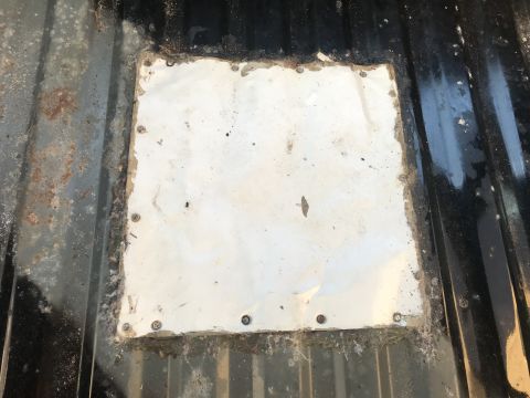 1992 Ford Bronco - Close-up of a patched metal floor section, likely from a vehicle's interior.