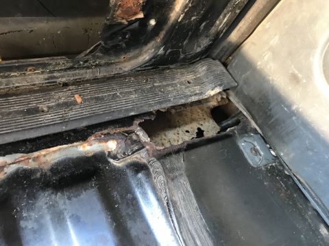 1992 Ford Bronco - Significant rust damage is visible on the interior floor panel of the vehicle.