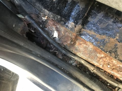 1992 Ford Bronco - Significant rust damage is visible on the rocker panel, indicating extensive corrosion.