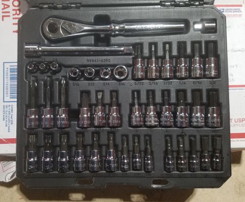 2000 Ford Crown Victoria - A tool kit containing a ratchet and various socket bits is neatly organized within its case.
